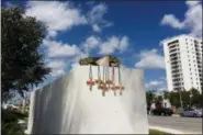  ?? JENNIFER KAY — THE ASSOCIATED PRESS ?? Six crosses are placed at a makeshift memorial on the Florida Internatio­nal University campus in Miami on Saturday near the scene of a pedestrian bridge collapse that killed at least six people on March 15.