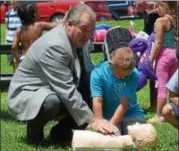  ??  ?? Cohoes Mayor Shawn Morse, who is a retired city firefighte­r, helps teach CPR to seven-year-old Dustin Hanna Wednesday afternoon in Lansing’s Park and Pool.