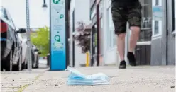  ?? JULIE JOCSAK TORSTAR FILE PHOTO ?? A discarded mask on the sidewalk on James Street in downtown St. Catharines in June. At least 142 Niagara residents with COVID-19 have died since the first local pandemic death was recorded in March.