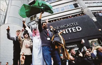  ?? ?? Newcastle United fans react to the announceme­nt of the takeover outside St James’ Park on Thursday