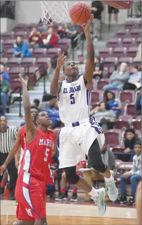  ?? Mara Kuhn/The Sentinel Record ?? To the rim: El Dorado's Czar Perry goes up for a basket as Marion's Keyshawn Woods defends during their game at the 6A State Tournament on Thursday at Lake Hamilton High School. The Wildcats downed Marion 56-53 to advance to the semifinals on Saturday.