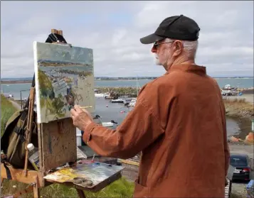  ??  ?? Thomas King from Carne who was painting in Rosslare Harbour as part of the Art in the Open plein air painting festival.