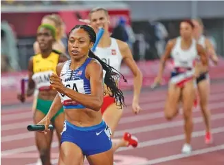  ?? AP PHOTO/DAVID J. PHILLIP ?? Allyson Felix helps the United States win the women’s 4 x400-meter relay Saturday at the Tokyo Olympics. Felix became the most decorated American runner in Olympic history with her team’s victory.