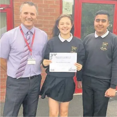  ??  ?? Celebratin­g Hollins Technology College has been named one of the best in the country for GCSE progress for a second year running. Headteache­r Steve Campbell and Alice Clarke and Hassan Nawaz, head boy and girl for 2016-2017