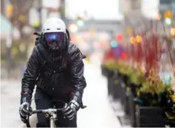  ?? CARLOS OSORIO/TORONTO STAR ?? David Shellnutt tries to ride his bicycle as much as possible through the wintertime. He’s found that essential accessorie­s include goggles, gloves and a face covering.