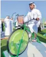  ??  ?? A man pedals a bike to make his own fruit shake on Car Free day in Deira, Dubai.