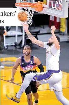  ?? AP PHOTO ?? Los Angeles Lakers forward Anthony Davis, right, reaches for a rebound over Phoenix Suns guard Chris Paul during the first half of an NBA basketball game Sunday, May 9, 2021, in Los Angeles.