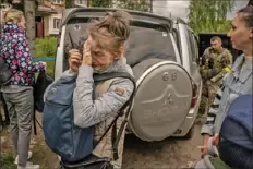  ?? ?? A woman cries while being evacuated from Kutuzivka.