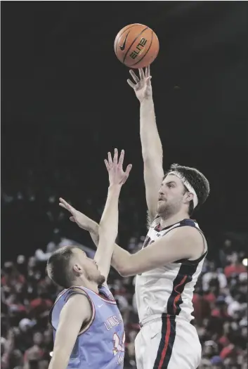  ?? YOUNG KWAK/AP ?? Gonzaga forward Drew Timme, right, shoots over Lewis-Clark State forward Al Sommerfiel­d during the first half of a college basketball exhibition game Friday in Spokane, Wash.