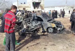  ?? (Reuters) ?? RESIDENTS INSPECT the site of an explosion in Atmeh yesterday, near a field hospital in the Syrian town next to the Turkish border.