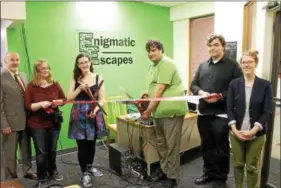  ?? LAUREN HALLIGAN — LHALLIGAN@ DIGITAL FIRST MEDIA.COM ?? A ribbon cutting ceremony for Enigmatic Escapes, which recently opened in the Troy Atrium in downtown Troy.