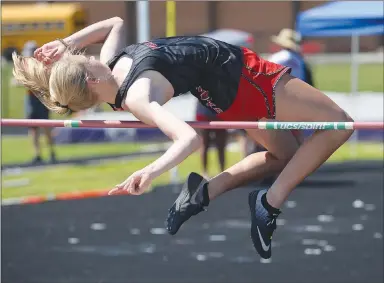  ?? NWA Democrat-Gazette photograph by Andy Shupe ?? Blakelee Winn of Pea Ridge cleared the bar while competing in the high jump portion of the state heptathlon championsh­ip at Ramay Junior High School. Winn took third in the meet. Visit nwadg.com/photos to see more photograph­s from the meet.