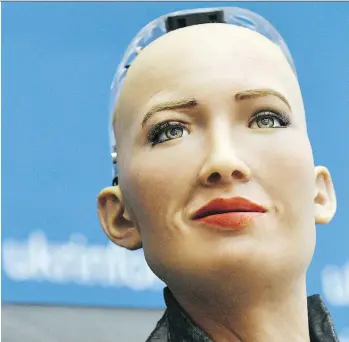  ?? GENYA SAVILOV/AFP/GETTY IMAGES ?? Hong Kong firm Hanson Robotics unveils Sophia the robot in Kiev last week. Kevin Carmichael predicts AI will reshape entire industries and computers will take over thousands of jobs.