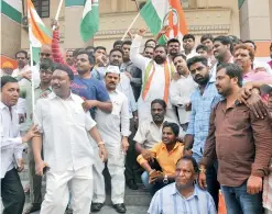  ??  ?? Congress workers celebrate at Gandhi Bhavan after hearing the news of BS Yeddyurapp­a quiting as Karnataka Chief Minister before a trust vote.