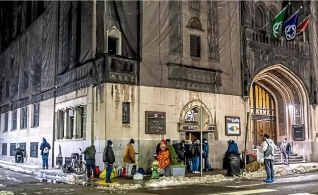  ?? Pittsburgh Post-Gazette ?? People wait outside of Pittsburgh Mercy’s Operation Safety Net winter shelter at the Smithfield United Church of Christ on Jan. 19, Downtown.