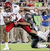  ?? Arkansas Democrat-Gazette/BENJAMIN KRAIN ?? Arkansas State’s Blake Mack is tackled by SMU safety Rodney Clemons during the first half of Saturday night’s game in Dallas. ASU led 14-10 after one quarter, but SMU took over after that.