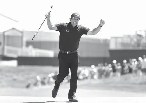  ?? Frank Franklin II/Associated Press ?? ■ Phil Mickelson reacts after sinking a putt on the 13th hole during the final round of the U.S. Open Golf Championsh­ip on Sunday in Southampto­n, N.Y. Mickelson brought attention to a tough setup on Saturday when he intentiona­lly hit a putt with the...