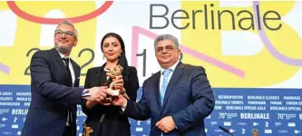  ??  ?? (From left) Iranian producer Farzad Pak, Iranian actress Baran Rasoulof and Iranian producer Kaveh Farnam pose with trophy on behalf of Iranian director Mohammad Rasoulof who was awarded the “Golden Bear for Best Film” pose with the trophy.