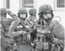  ?? TIMOTHY A. CLARY/AFP/GETTY IMAGES ?? A police SWAT team searches houses in Watertown, Mass., for the second of two suspects wanted in the Boston Marathon bombings.