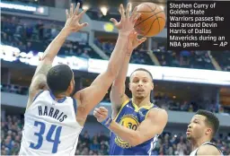  ?? —AP ?? Stephen Curry of Golden State Warriors passes the ball around Devin Harris of Dallas Mavericks during an NBA game.