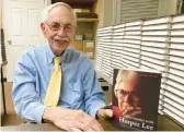  ?? JAY REEVES/AP ?? Historian Wayne Flynt holds a copy of his book “Afternoons with Harper Lee,” about the author of “To Kill a Mockingbir­d” who died in 2016, on Sept. 22 in Alabama.