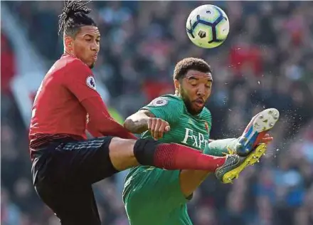  ?? EPA PIC ?? Manchester United’s Chris Smalling (left) and Watford’s Troy Deeney fight for the ball at Old Trafford on Saturday.