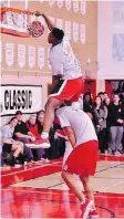  ?? SANDRA SURKAN. ?? Fofo Adetogun of Notre Dame leaps over Jashon Henry during the slam dunk competitio­n at the Fekula Senior Classic basketball tournament on Friday.