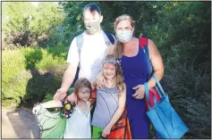  ?? (NWA Democrat-Gazette/Carin Schoppmeye­r) ?? Wade and Brandy January, with daughters Charlotte (left) and Sydney, attend a Magical Evening in the Garden on July 12.