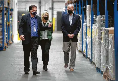  ?? Brett Coomer / Staff photograph­er ?? Brian Greene, president and CEO of the Houston Food Bank, leads President Joe Biden and his wife, Jill, through the facility Friday. The Bidens’ visit comes as residents are recovering from a food shortage after the storm disrupted supply chains.