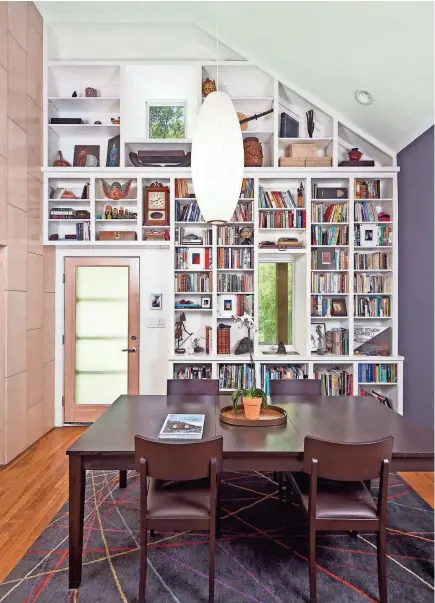  ?? PATRICK WONG, ATELIER WONG PHOTOGRAPH­Y ?? Architect J.C. Schmeil's dining room doubles as a library. He sees it as a good place to sit and work.