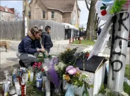  ?? Shafkat Anowar/Associated Press ?? Lupita Padilla lights a candle Friday as she pays her respect to a memorial where 13-year-old Adam Toledo was shot by police in the Little Village neighborho­od of Chicago.