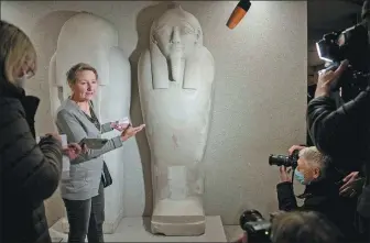  ?? STEFANIE LOOS / AFP ?? Friederike Seyfried, director of the Egyptian Museum Berlin, on Wednesday points to the damage caused by an “oily liquid” leaving visible stains on exhibits in the Egyptian part of the Neues Museum.