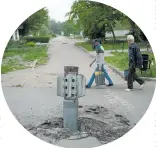  ?? Photo / AP ?? A rocket wedged in the ground in Lysychansk, Ukraine.