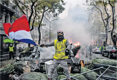  ??  ?? The gilets jaune protests in 2018 in Paris. Now the health pass has provoked the French once again