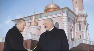  ??  ?? MINSK, Belarus: Turkey’s President Recep Tayyip Erdogan (left) and Belarusian President Alexander Lukashenko shake hands during the inaugurati­on ceremony of a mosque yesterday.