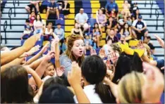  ?? PHOTO VINCENT OSUNA ?? Brawley Union High head cheer coach Megan Griggs leads camp goers in a break during the 2019 Future Wildcat Cheer Camp on Saturday at BUHS in Brawley.