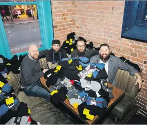  ??  ?? From left, Chris Badyk, Kye Agrios, Garrete Resler and Damon Holowchak will be among other Donnelly Group staff, who will spread out across downtown Vancouver on Christmas Day to distribute soups and sandwiches, socks, gloves and toques to those less...