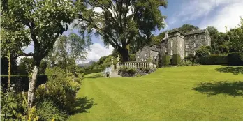  ??  ?? CLOCKWISE FROM TOP Plas Brondanw; Amabel with her father John St Loe Strachey on her wedding day to Clough William-Ellis; yew arches against a dramatic mountain at Plas Brondanw; the orangery at Plas Brondanw