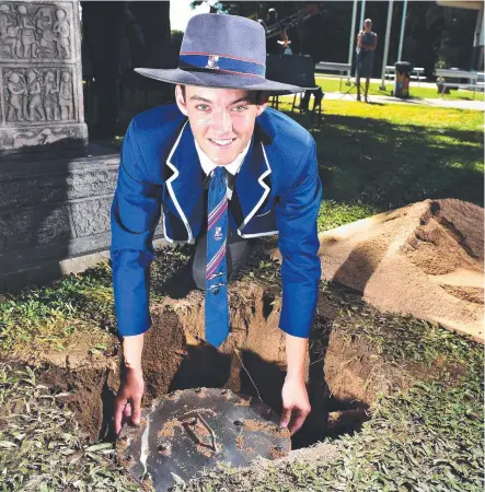  ?? Picture: SHAE BEPLATE ?? BURIED TREASURE: Ignatius Park College school captain Thomas Harte buries the time capsule.