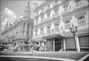  ?? AP/RAMON ESPINOSA ?? An old American automobile sits outside the Inglaterra hotel in Havana on Saturday. President Donald Trump’s new policy on Cuba will still allow U.S. citizens to travel there, but not as easily.