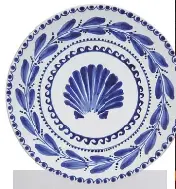  ?? ?? BELOW: A plate by rising talent Gergei Erdei (p.44) and a brass chair from Mumbai’s new design gallery Aequo (p.36).