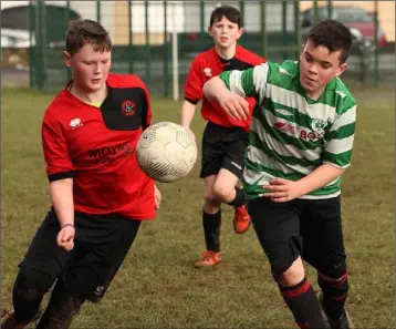  ??  ?? Jason Murphy (Camolin Celtic) and Max O’Neill (Gorey Celtic) are both eager to secure possession.
