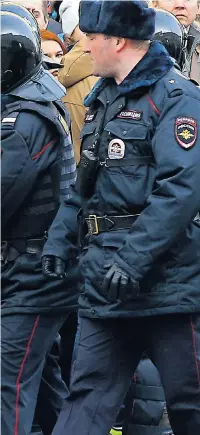  ??  ?? A woman is restrained by policemen in Moscow, and top right, a man is dragged away amid protests prompted by a film by campaigner Alexei Navalny, left, who was also arrested