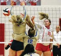  ??  ?? Senior middle blocker Emma Jubela, who had five kills for the Cougarette­s, pops the ball past Kerrville Tivy defenders.