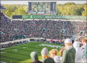  ?? STEPHEN SPERANZA / THE NEW YORK TIMES ?? An advertisem­ent promotes a betting app Oct. 8 at Michigan State’s football game against Ohio State in East Lansing, Mich. To reap millions of dollars in fees, universiti­es are partnering with betting companies to introduce their students and sports fans to online sports gambling.