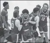  ?? Associated Press ?? HAPPY WIN UCLA players celebrate following an 8680 overtime win against Michigan State in the First Four of the NCAA Tournament, on Thursday at Mackey Arena in West Lafayette, Ind.