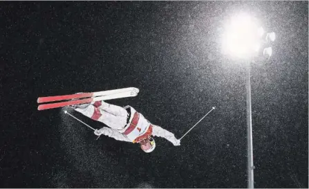  ?? CAMERON SPENCER GETTY IMAGES ?? Mikael Kingsbury soars to his first gold medal in Olympic moguls Monday, making it three straight for Canada.