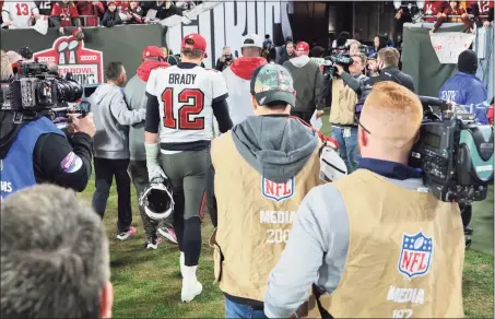  ?? Alex Menendez / Associated Press ?? Buccaneers quarterbac­k Tom Brady (12) walks off the field after a loss to the Rams in a divisional playoff game on Jan. 23.