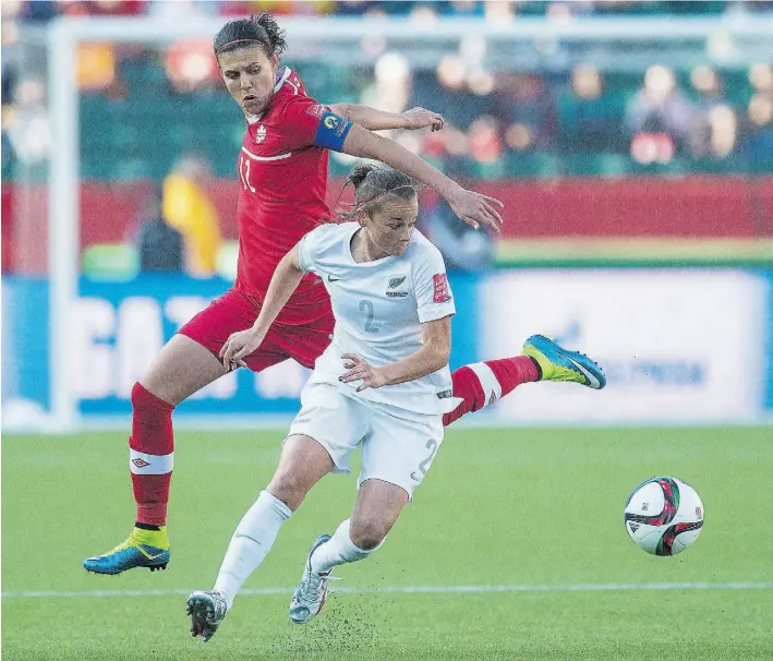  ?? Shaughn Butts/Edmonton Journal ?? Christine Sinclair of Canada flies past New Zealand’s Ria Percival at Commonweal­th Stadium on Thursday. The match ended in a 0-0 draw. Canada plays the Netherland­s Monday in Montreal.