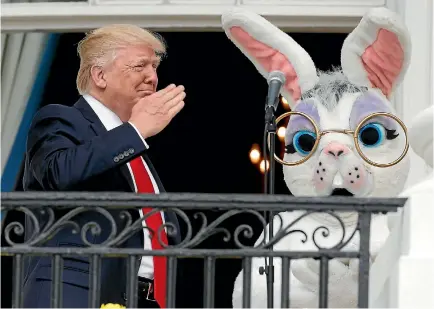  ?? PHOTO: REUTERS ?? United States President Donald Trump salutes a member of the US military who sang the national anthem as he shares the White House’s Truman Balcony with a performer in an Easter Bunny costume, at the White House Easter Egg Roll.